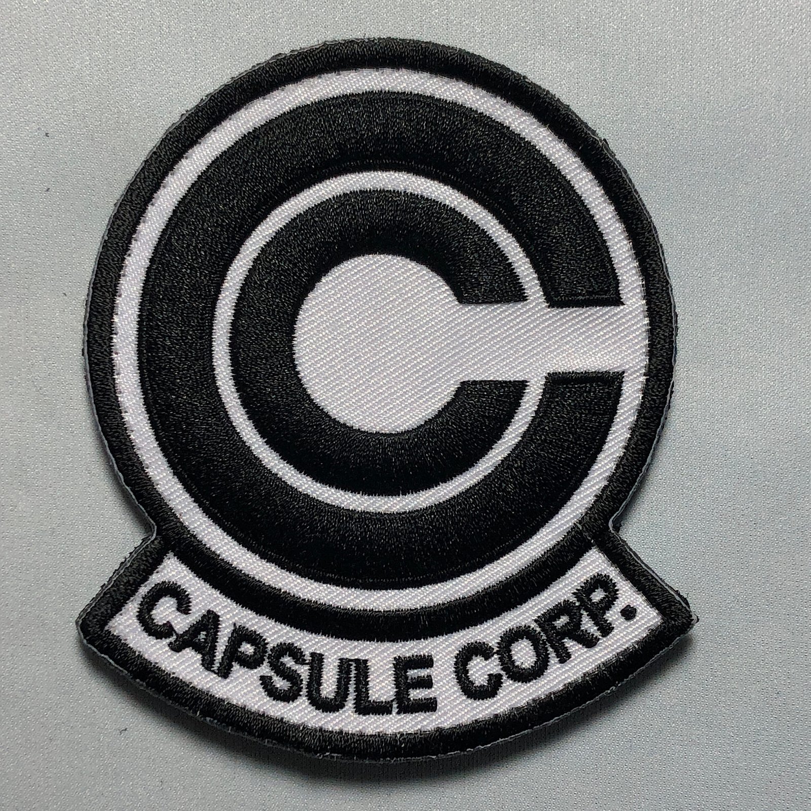 Black CAPSULE Corp. Morale Patch: Movie Emblem for Cosplay Uniform Jacket Mask Airsoft Comicon – Hook and Loop or Iron-On